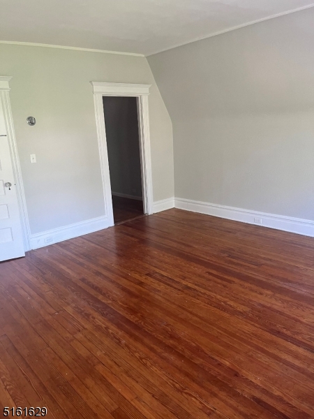 209 Hillside Avenue, Unit 2 Glen Ridge, NJ 07028 - Photo 15 of 17 a view of an empty room with wooden floor and a window