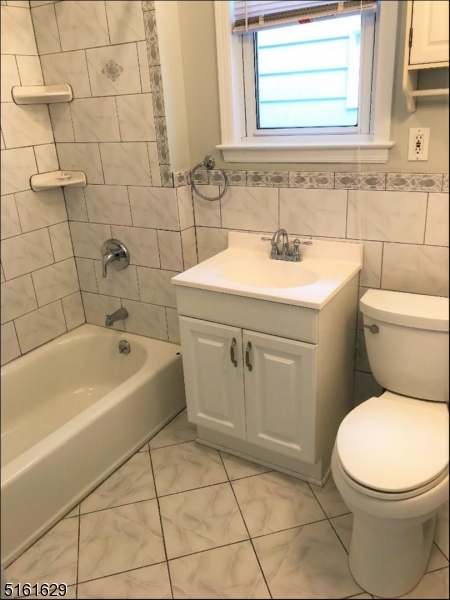 209 Hillside Avenue, Unit 2 Glen Ridge, NJ 07028 - Photo 16 of 17 a bathroom with a sink a toilet and bathtub
