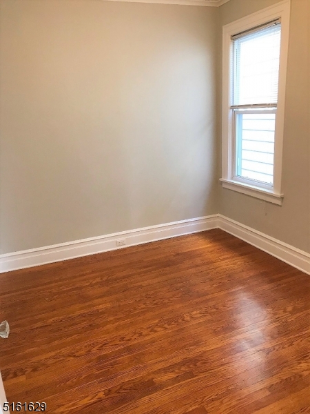 209 Hillside Avenue, Unit 2 Glen Ridge, NJ 07028 - Photo 4 of 17 wooden floor in an empty room