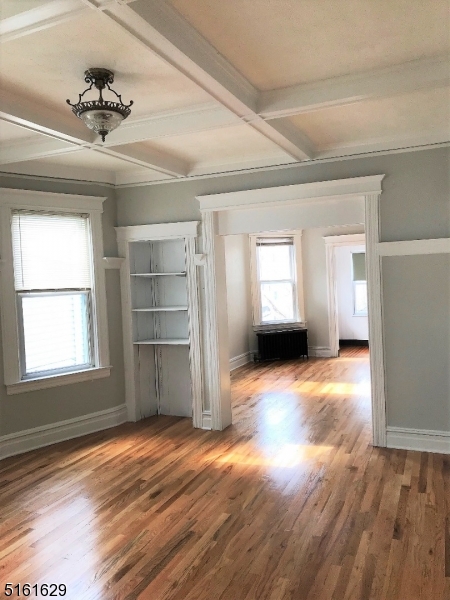 209 Hillside Avenue, Unit 2 Glen Ridge, NJ 07028 - Photo 7 of 17 a view of empty room with a window and wooden floor