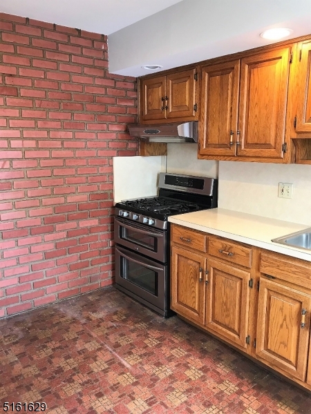 209 Hillside Avenue, Unit 2 Glen Ridge, NJ 07028 - Photo 8 of 17 a kitchen with stainless steel appliances a stove a sink and cabinets