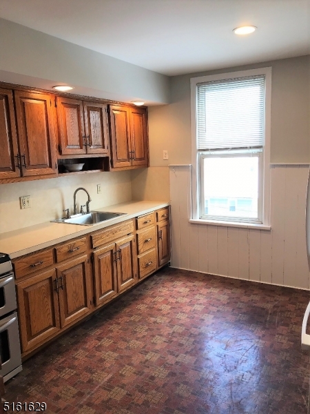 209 Hillside Avenue, Unit 2 Glen Ridge, NJ 07028 - Photo 9 of 17 a kitchen with a sink window and cabinets