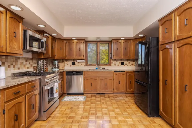 a view of a workspace with furniture and wooden floor