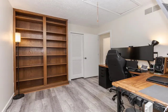 a bedroom with a bed a chandelier and a window