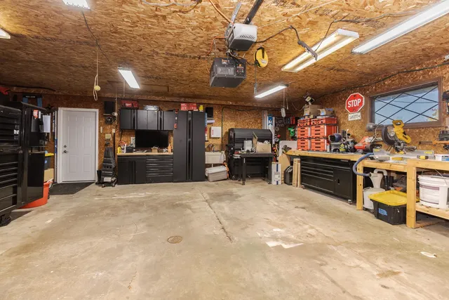 a view of backyard with small cabin and wooden fencing