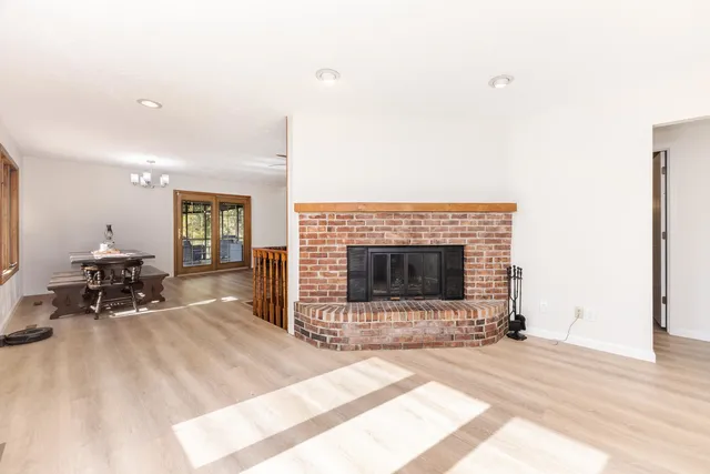 a view of a room with wooden floor and windows