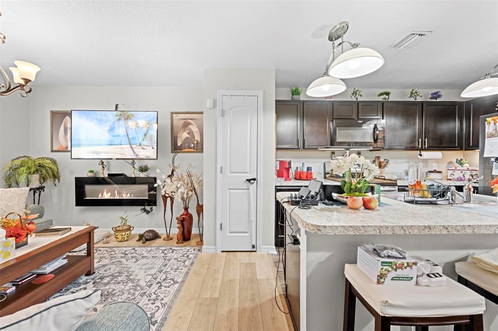 26448 Bertram Road Brooksville, FL 34602 - Photo 14 of 31 a kitchen view with microwave a stove and cabinets