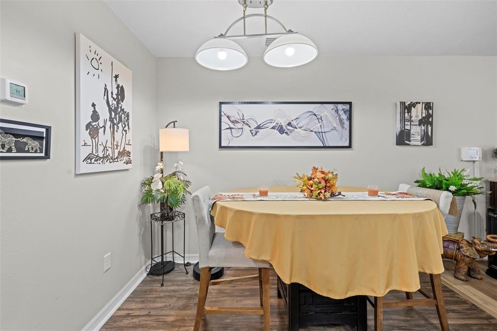 26448 Bertram Road Brooksville, FL 34602 - Photo 17 of 31 a view of a dining room with furniture and wooden floor