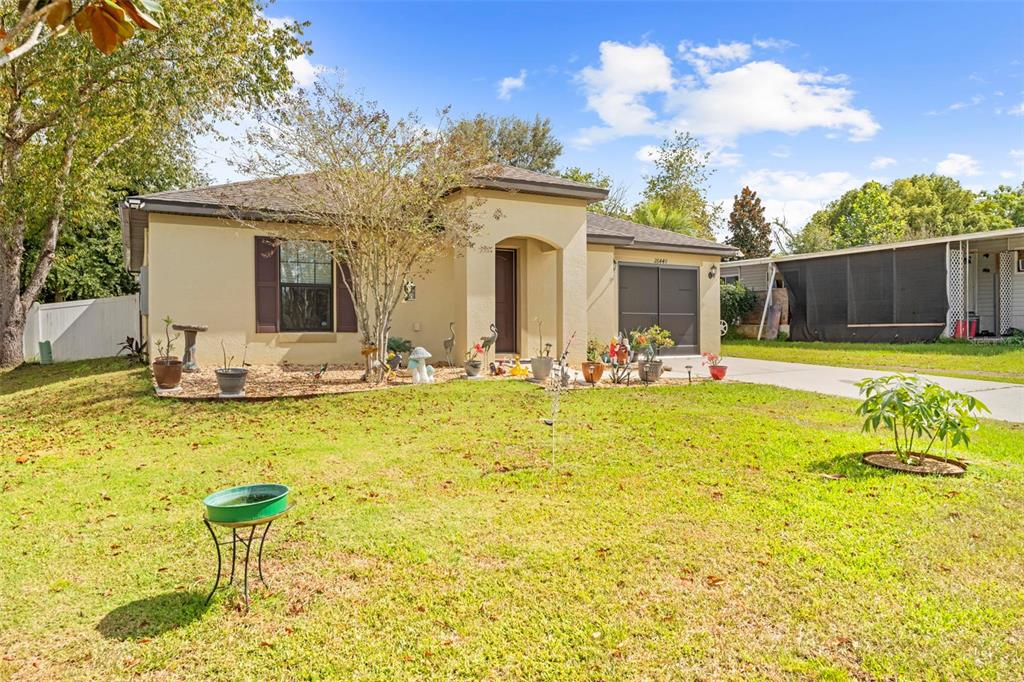 26448 Bertram Road Brooksville, FL 34602 - Photo 2 of 31 a front view of house with outdoor seating