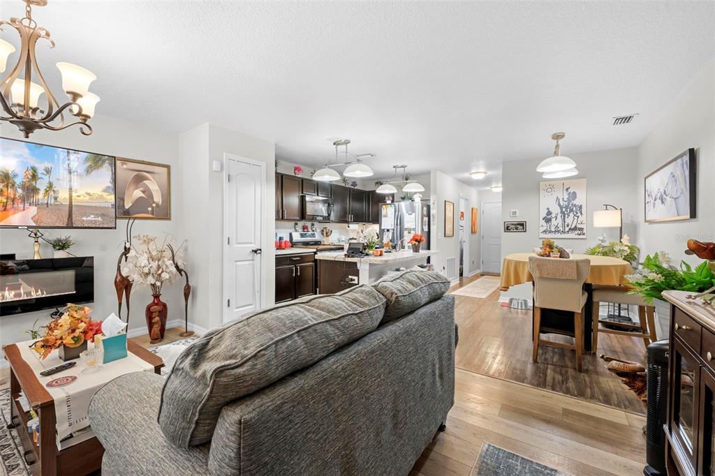 26448 Bertram Road Brooksville, FL 34602 - Photo 21 of 31 a living room with lots of furniture and kitchen view