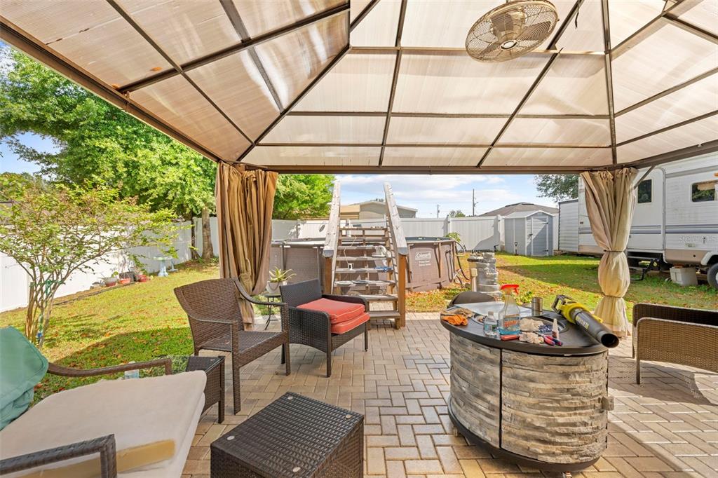 26448 Bertram Road Brooksville, FL 34602 - Photo 27 of 31 a outdoor space with the couches and dining table with the garden view