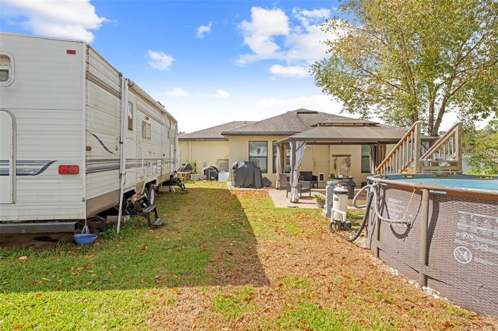 26448 Bertram Road Brooksville, FL 34602 - Photo 29 of 31 a view of a house with a patio