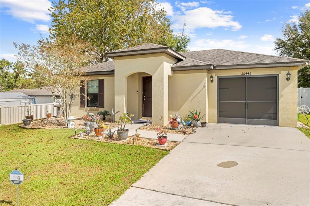 26448 Bertram Road Brooksville, FL 34602 - Photo 3 of 31 a view of a patio with table and chairs and potted plants