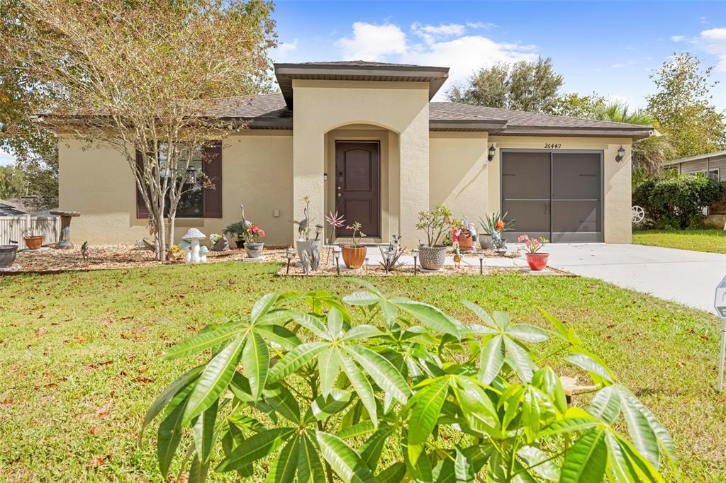 26448 Bertram Road Brooksville, FL 34602 - Photo 4 of 31 a front view of a house with outdoor seating