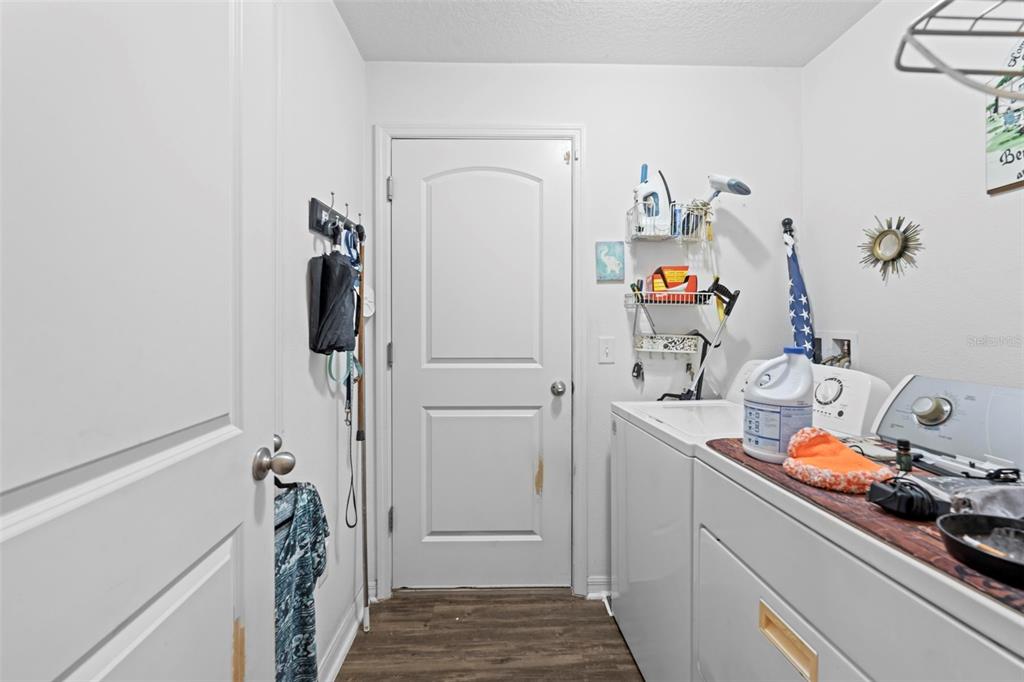 26448 Bertram Road Brooksville, FL 34602 - Photo 5 of 31 a storage room with a washer and dryer