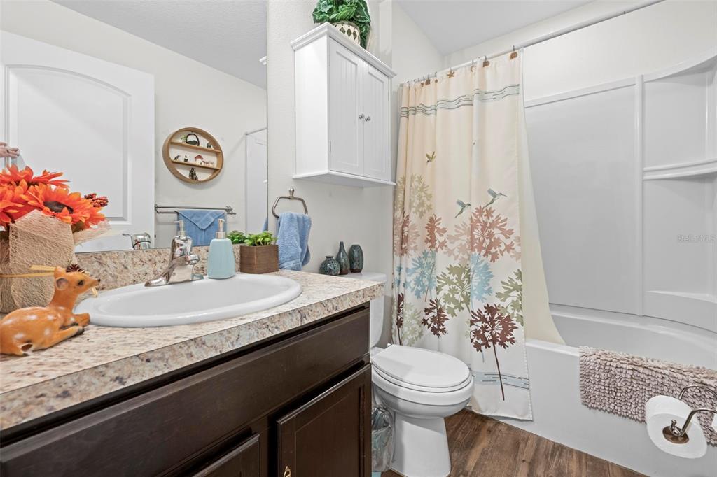 26448 Bertram Road Brooksville, FL 34602 - Photo 7 of 31 a bathroom with a granite countertop sink and a mirror