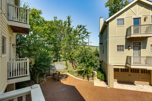 a view of a house with a yard and sitting area