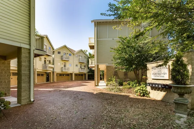 a view of a street with houses on the road
