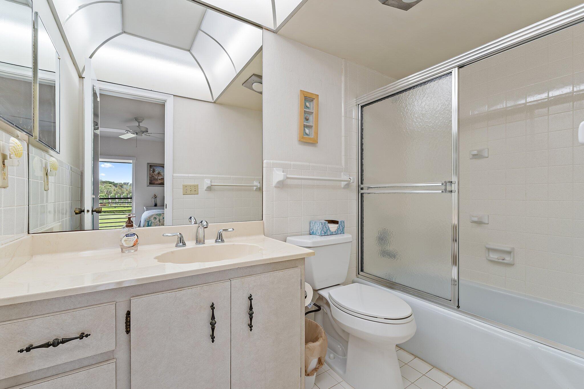 755 Saturn Street, Unit D 201 Jupiter, FL 33477 - Photo 15 of 42 a bathroom with a sink a toilet and shower