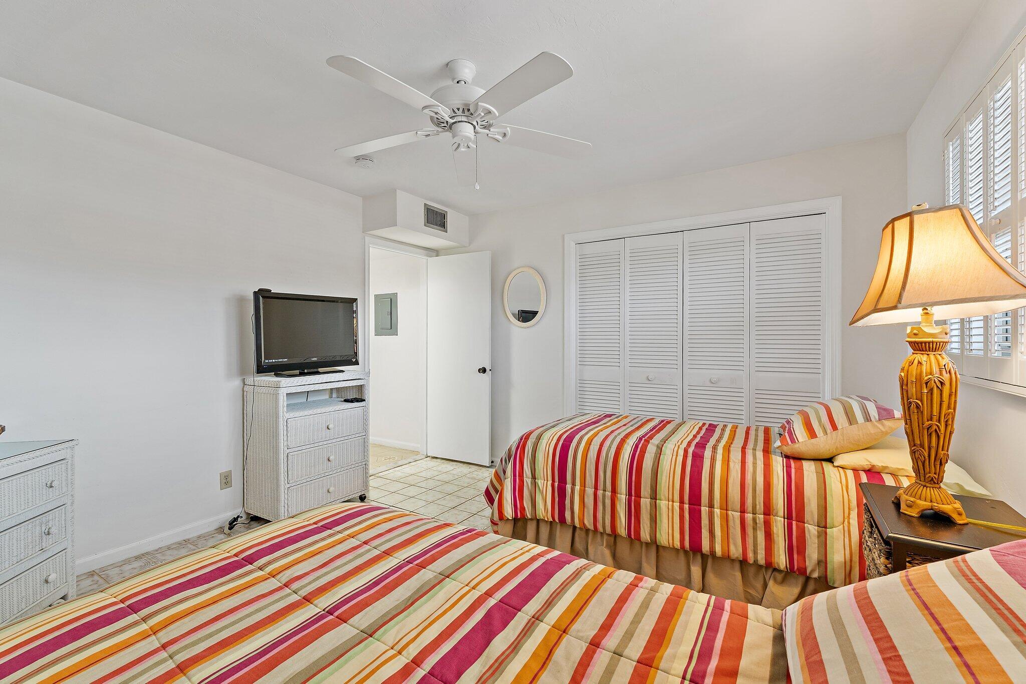 755 Saturn Street, Unit D 201 Jupiter, FL 33477 - Photo 18 of 42 a bedroom with a bed and flat screen tv