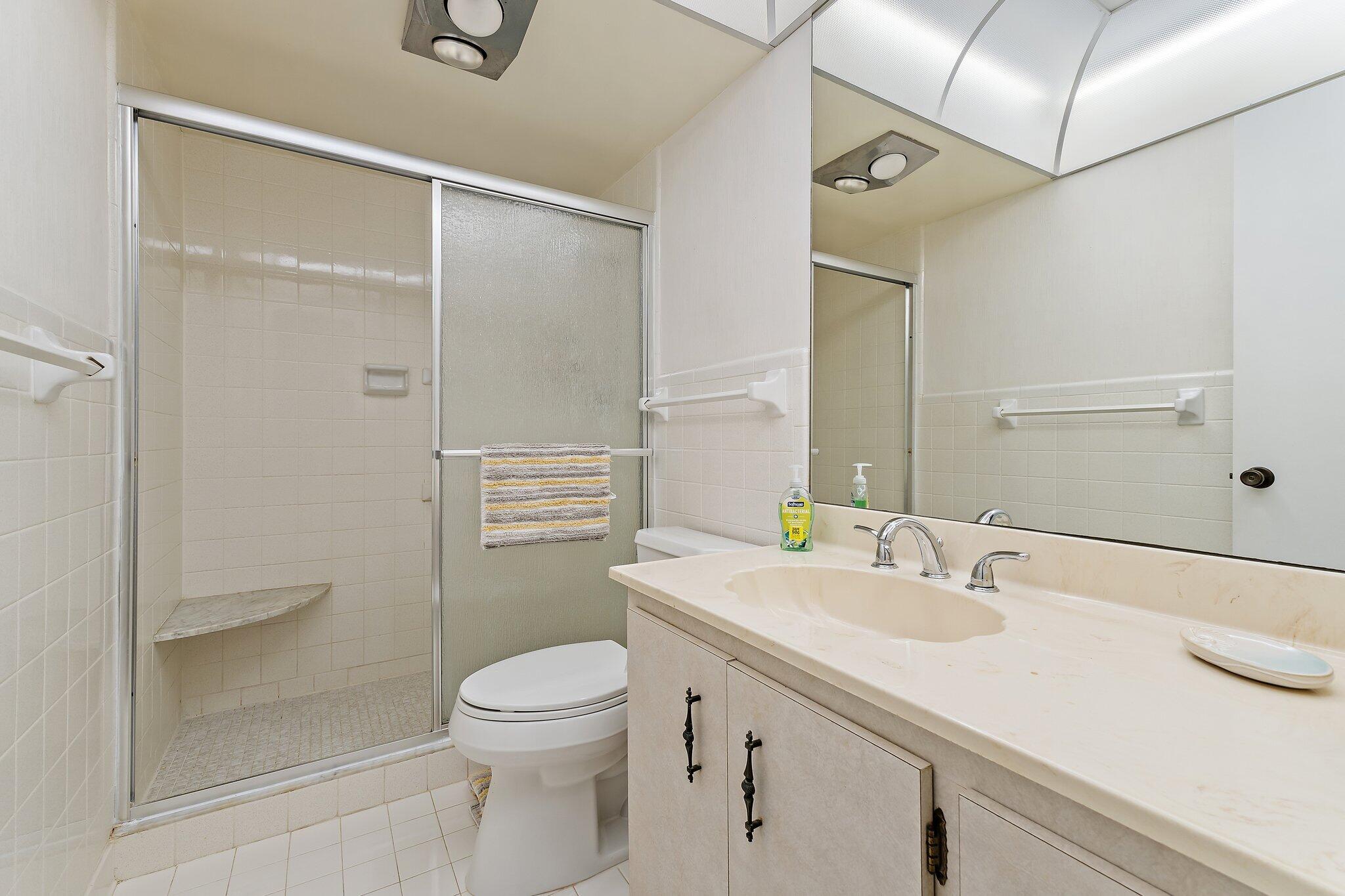 755 Saturn Street, Unit D 201 Jupiter, FL 33477 - Photo 19 of 42 a bathroom with a sink a toilet and shower