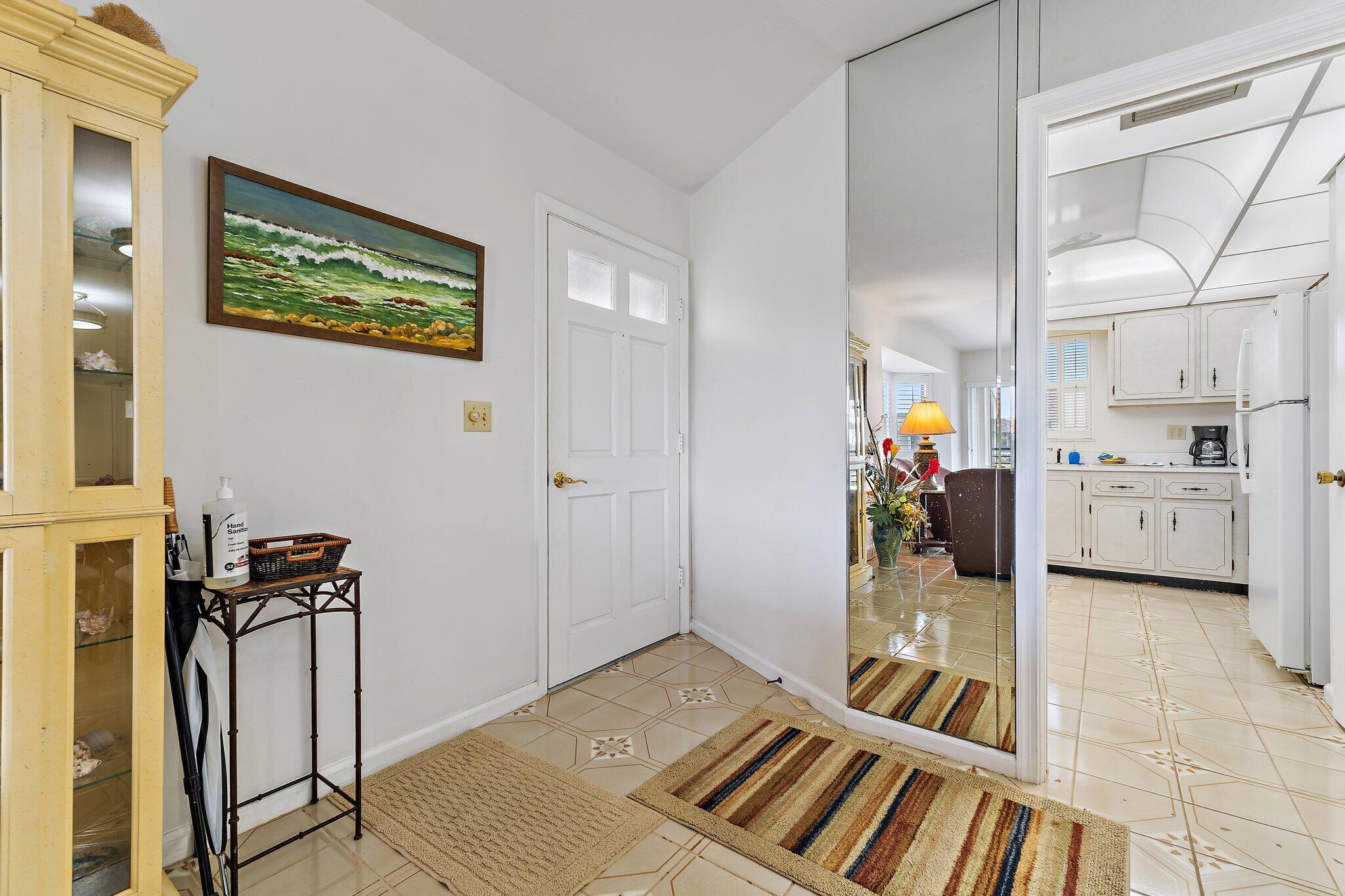 755 Saturn Street, Unit D 201 Jupiter, FL 33477 - Photo 20 of 42 a spacious bedroom with a bed and a view of bathroom