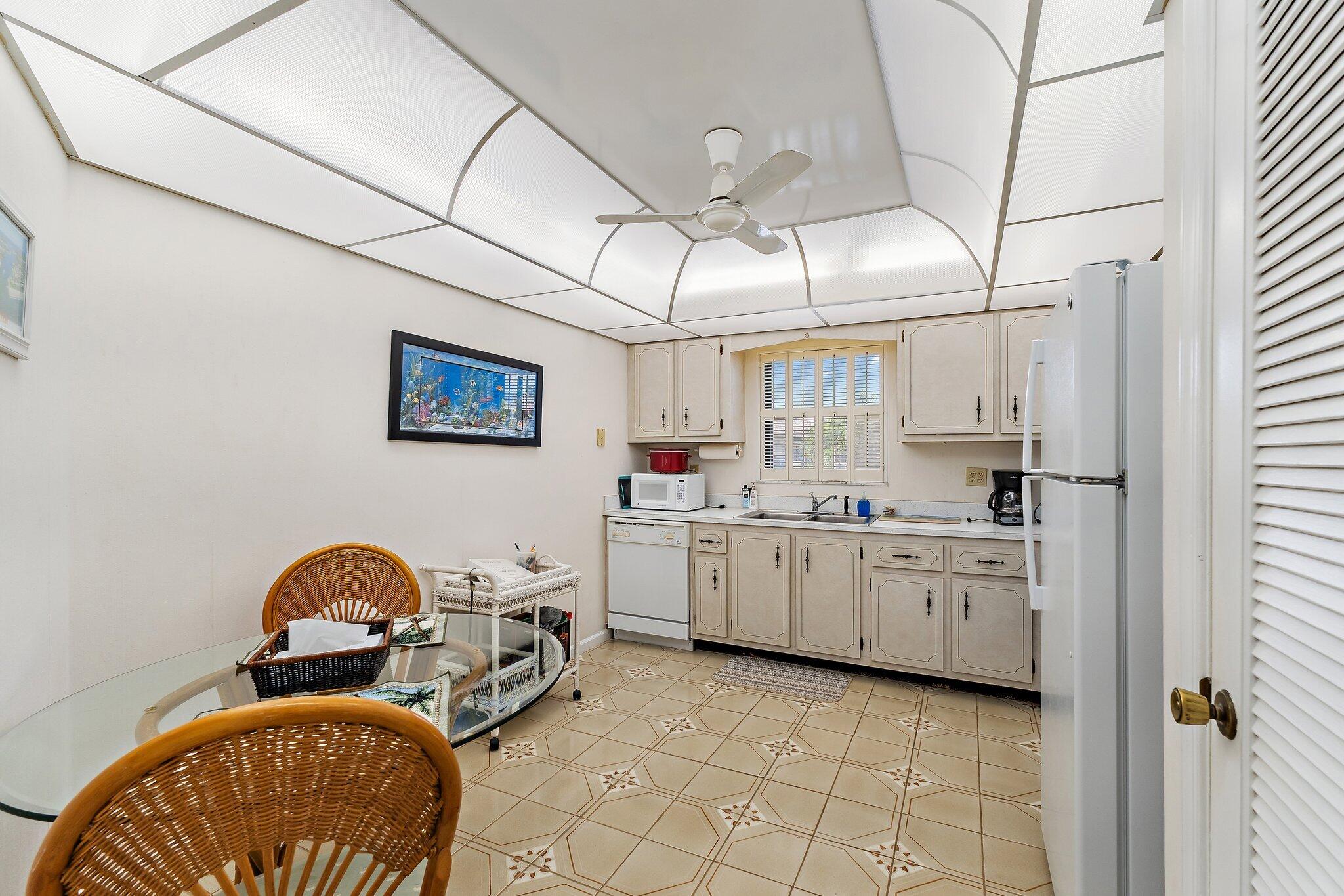 755 Saturn Street, Unit D 201 Jupiter, FL 33477 - Photo 28 of 42 a kitchen with sink cabinets and stove