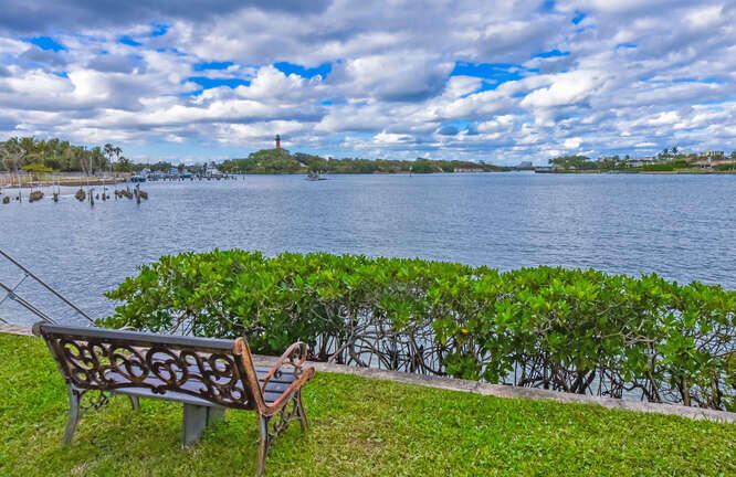 755 Saturn Street, Unit D 201 Jupiter, FL 33477 - Photo 32 of 42 a view of a lake with a garden in the back