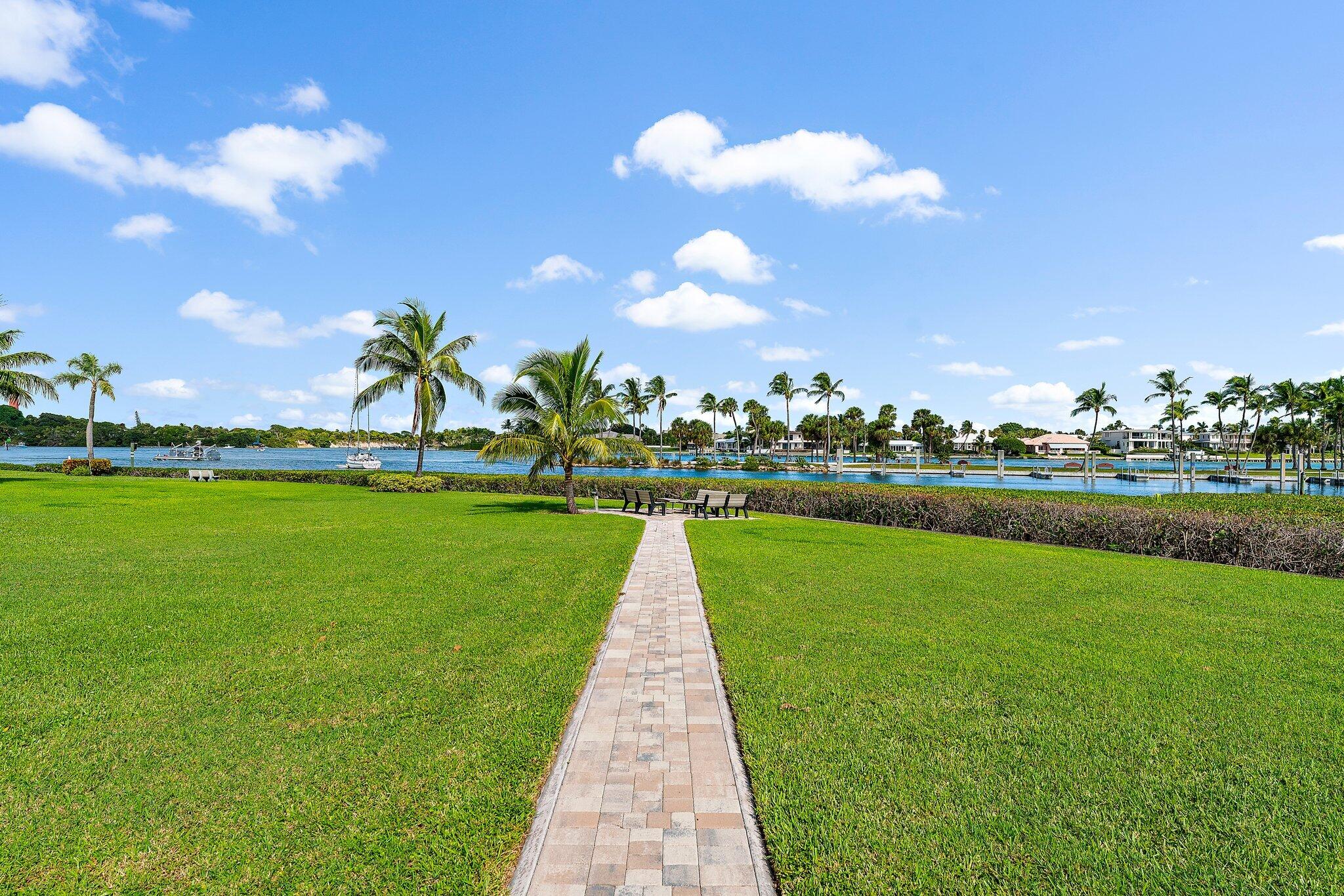 755 Saturn Street, Unit D 201 Jupiter, FL 33477 - Photo 40 of 42 a view of building with swimming pool and green space