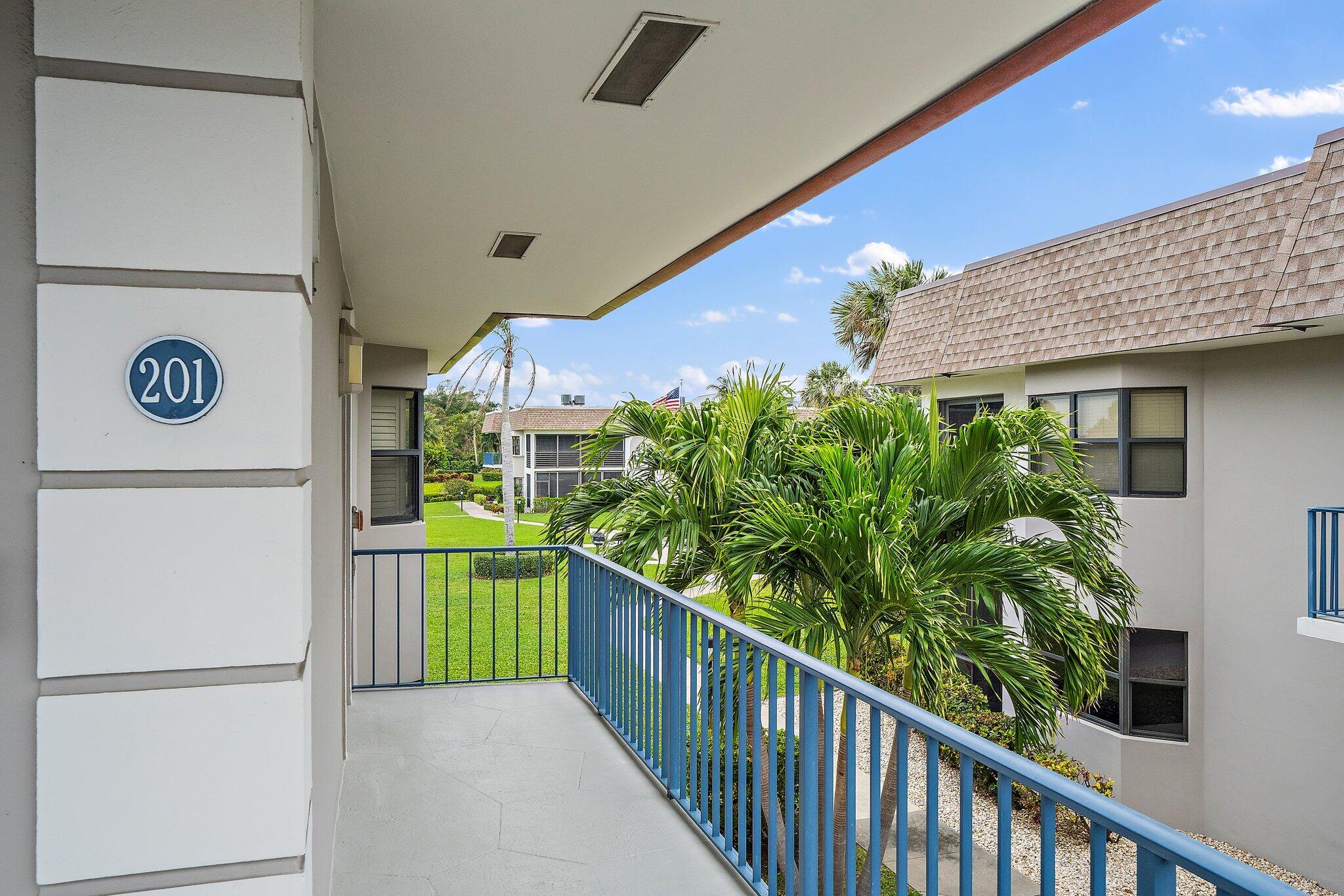 755 Saturn Street, Unit D 201 Jupiter, FL 33477 - Photo 4 of 42 a view of a pathway along with potted plants