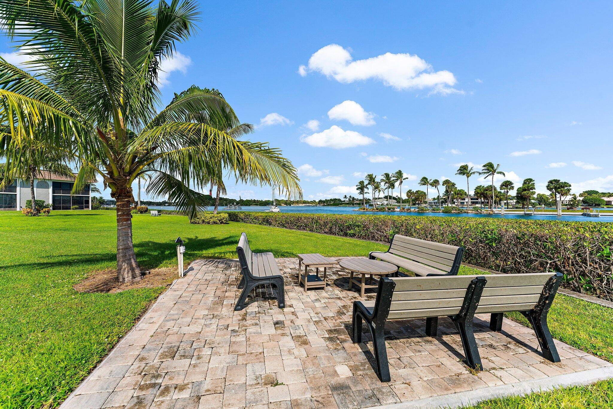 755 Saturn Street, Unit D 201 Jupiter, FL 33477 - Photo 41 of 42 a swimming pool with outdoor seating and yard