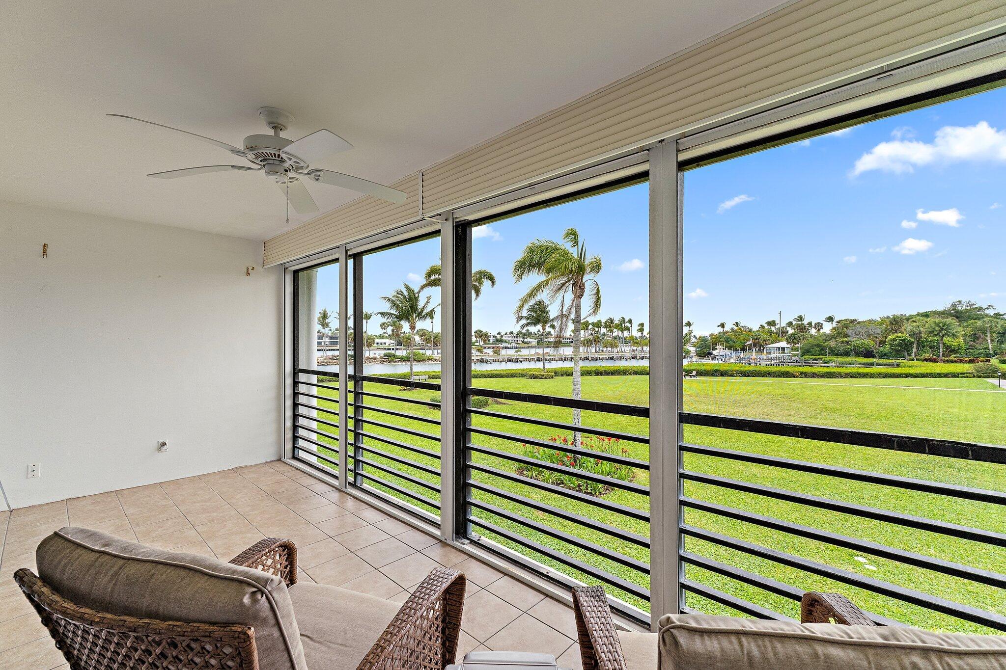 755 Saturn Street, Unit D 201 Jupiter, FL 33477 - Photo 7 of 42 a view of a porch with furniture and a yard