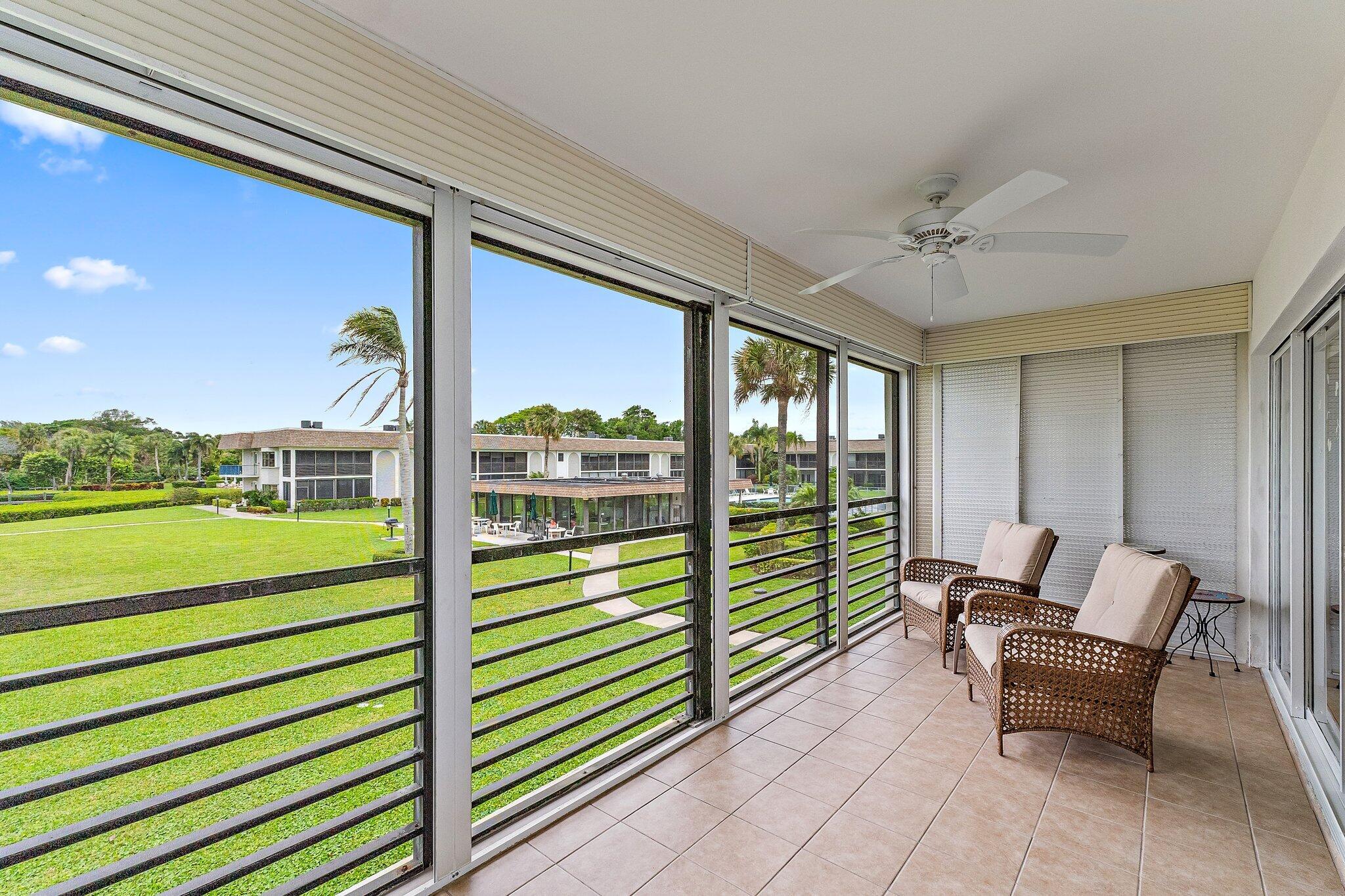 755 Saturn Street, Unit D 201 Jupiter, FL 33477 - Photo 8 of 42 a view of a porch with furniture and a yard