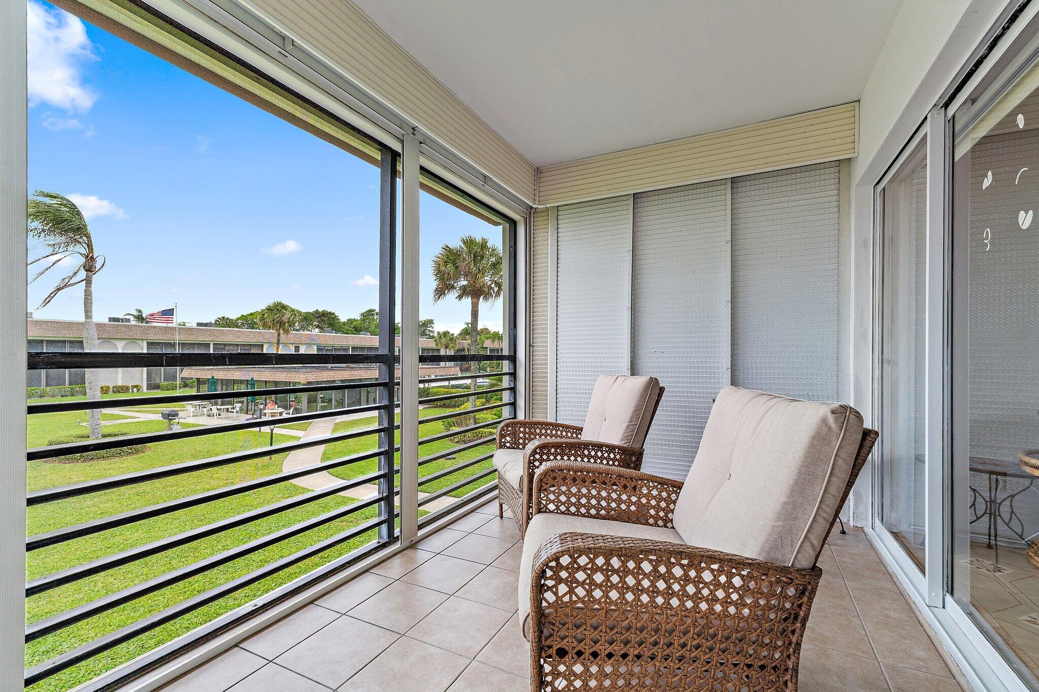755 Saturn Street, Unit D 201 Jupiter, FL 33477 - Photo 10 of 42 a view of a two chairs in the balcony