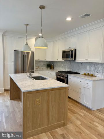 a kitchen with a stove a refrigerator and a sink