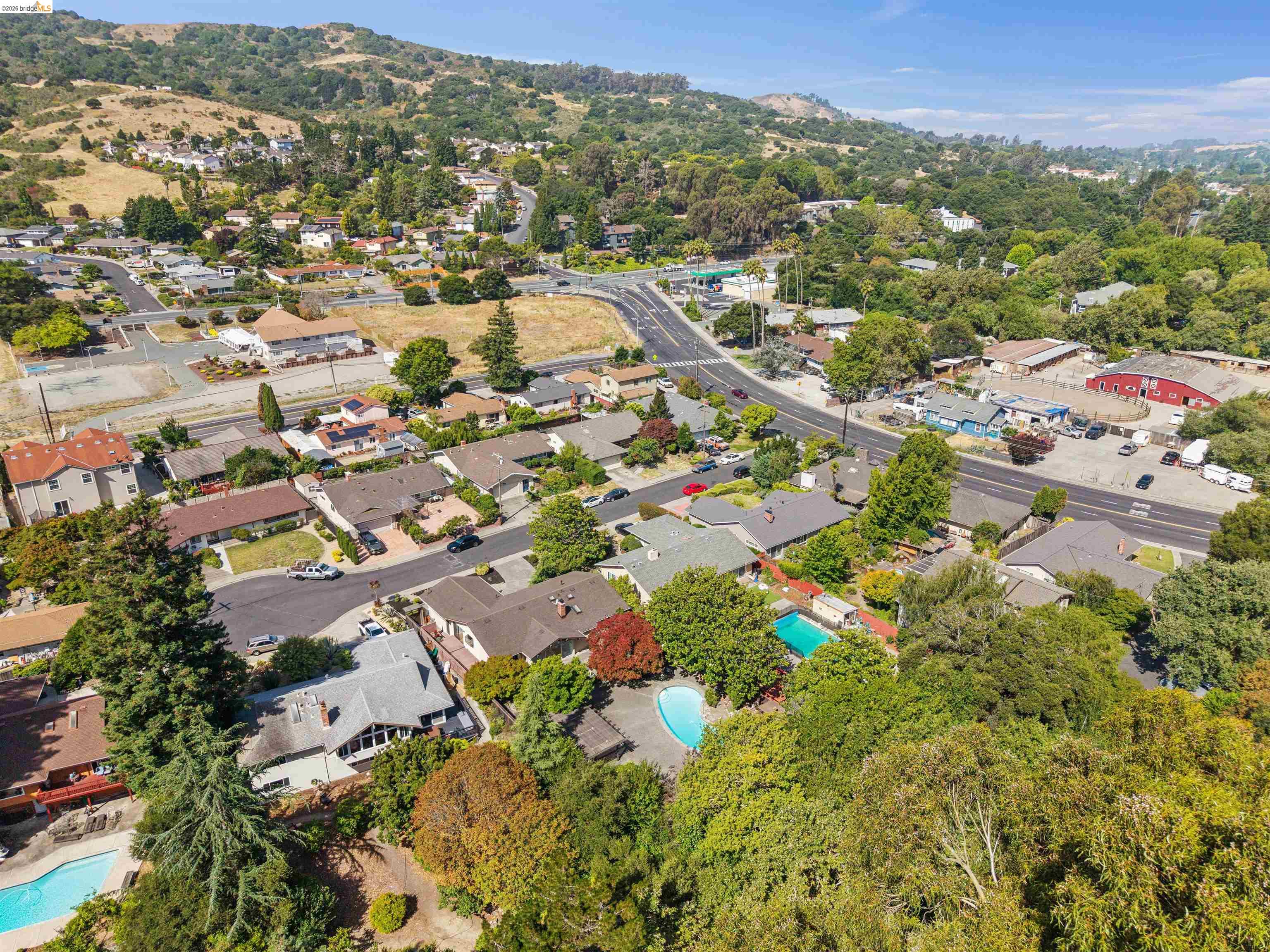 7 Jo Lin Court El Sobrante, CA 94803 - Photo 8 of 99 Aerial perspective showcasing a residential area with varied rooflines and extensive tree coverage