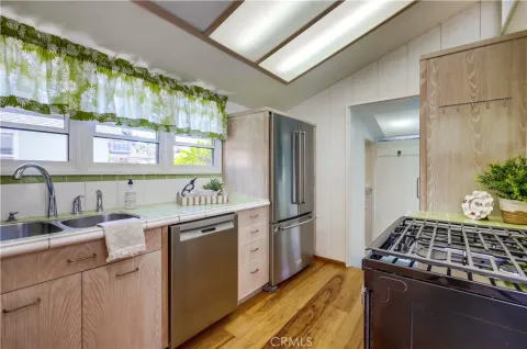 a view of a house with a yard and potted plants