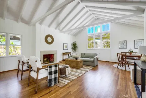 a living room with fireplace furniture and a large window