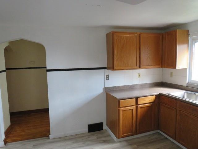 80 Woods Road Pittsburgh, PA 15235 - Photo 7 of 21 a kitchen with a refrigerator sink and cabinets