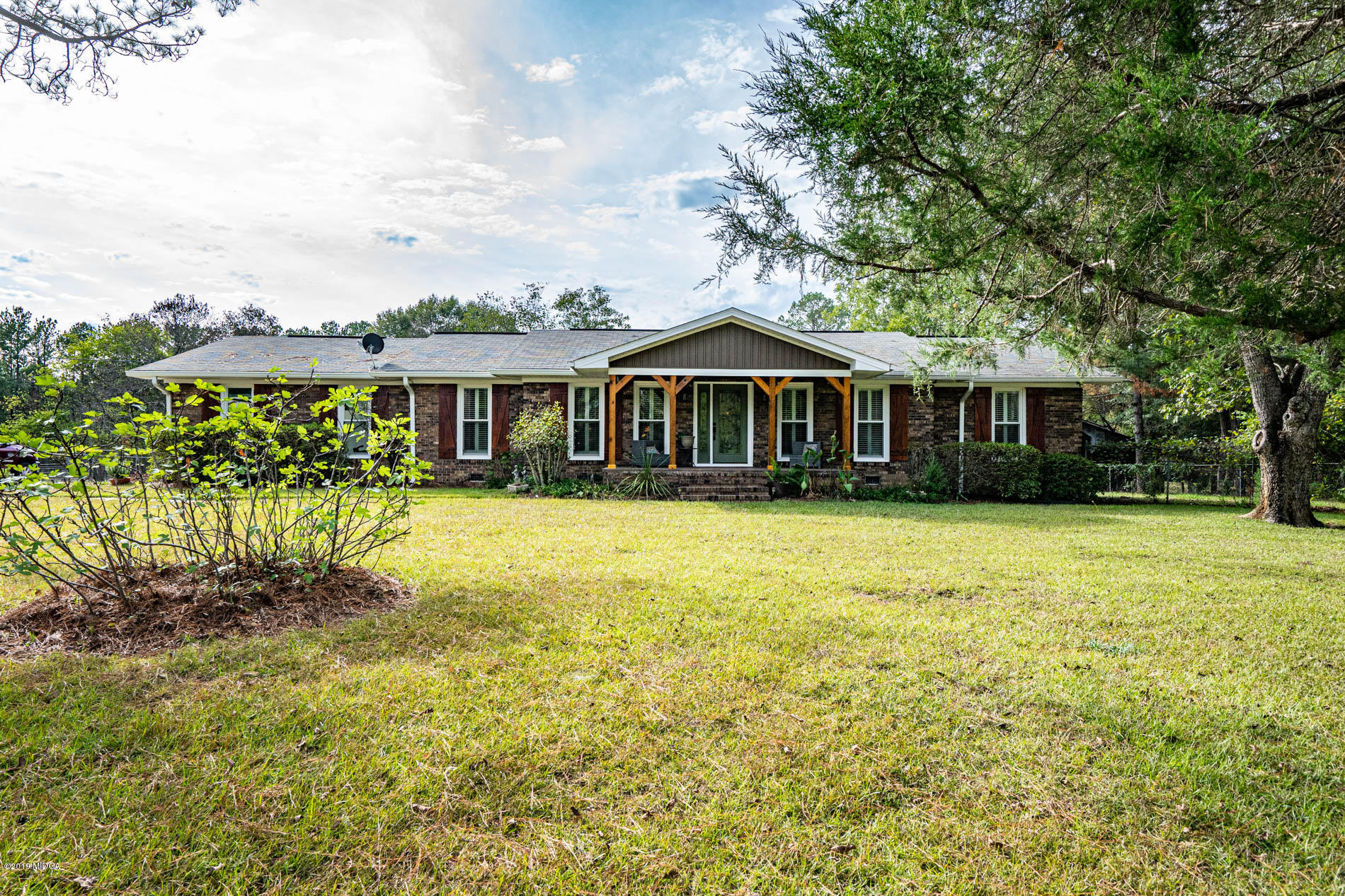 2064 Midway Road Lizella, GA 31052 - Photo 1 of 40 a front view of a house with a yard table and chairs