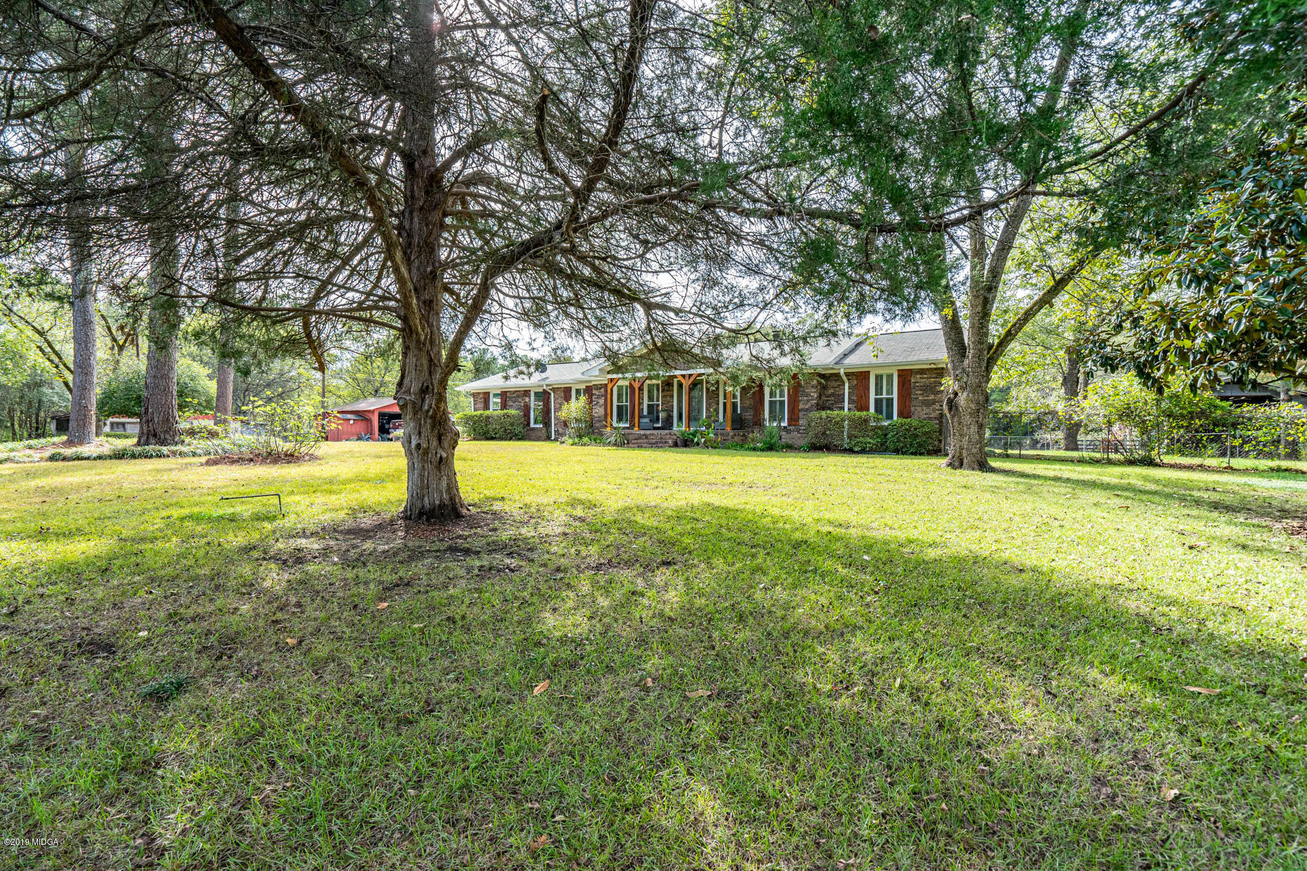 2064 Midway Road Lizella, GA 31052 - Photo 4 of 40 a view of a yard with a house and large trees