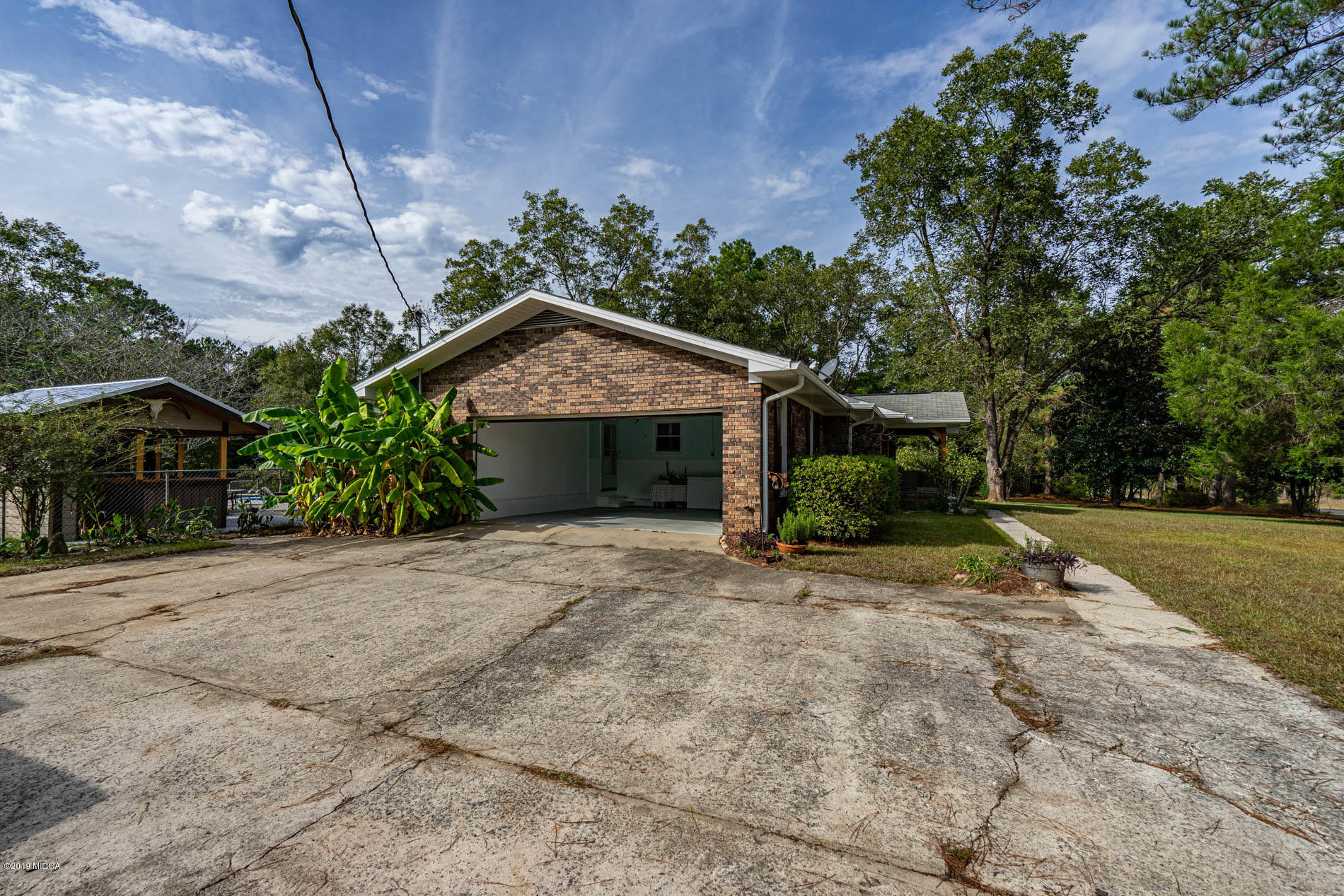2064 Midway Road Lizella, GA 31052 - Photo 36 of 40 a front view of a house with a yard and garage