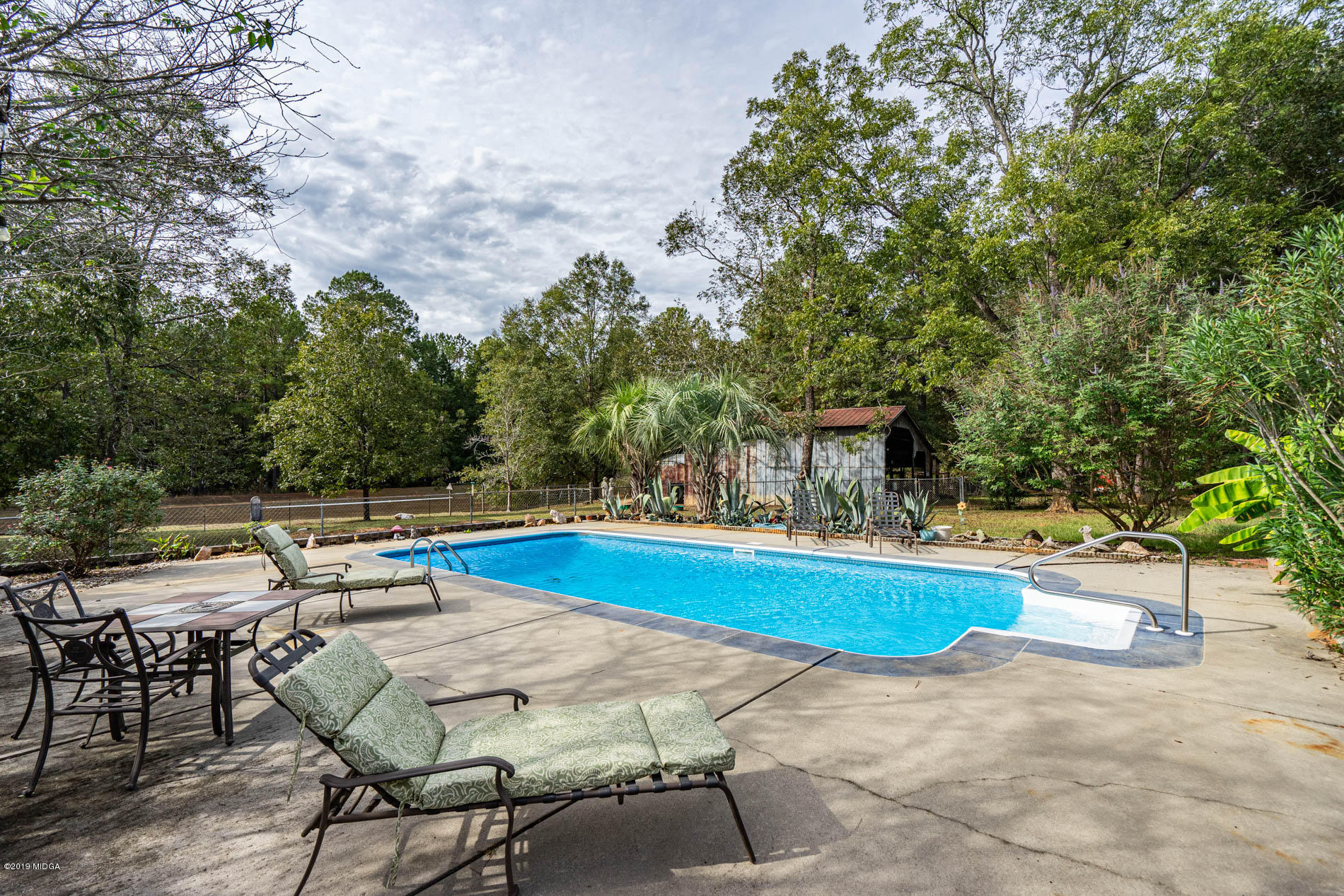 2064 Midway Road Lizella, GA 31052 - Photo 9 of 40 a view of backyard with swimming pool and seating space