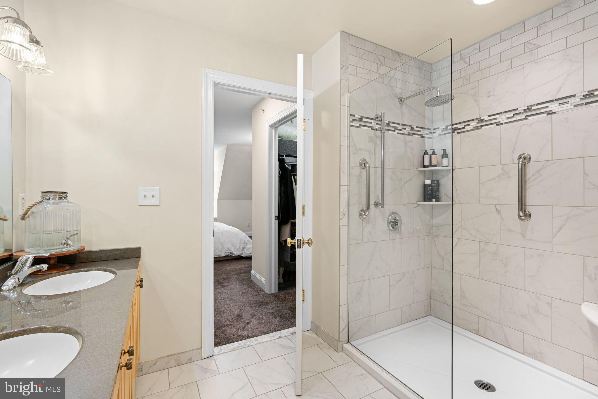 10 Washington Avenue Haddonfield, NJ 08033 - Photo 24 of 35 a bathroom with a granite countertop sink a mirror and a shower