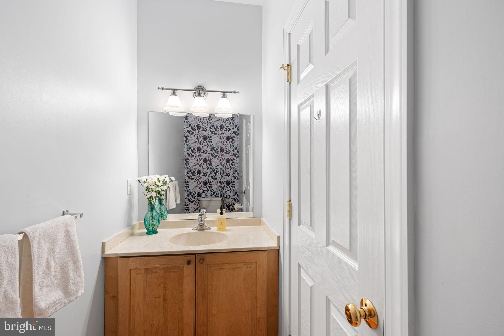 10 Washington Avenue Haddonfield, NJ 08033 - Photo 28 of 35 a bathroom with a granite countertop sink and a mirror