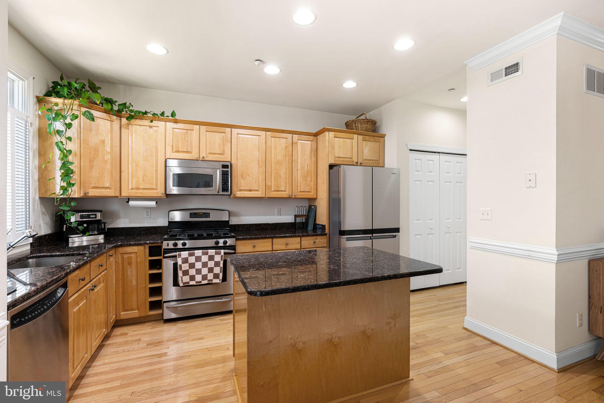 10 Washington Avenue Haddonfield, NJ 08033 - Photo 8 of 35 a kitchen with stainless steel appliances granite countertop a refrigerator a stove top oven a sink and dishwasher