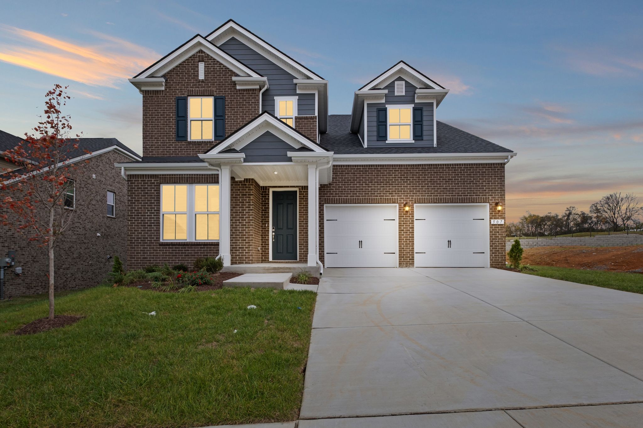 a front view of a house with a yard and garage