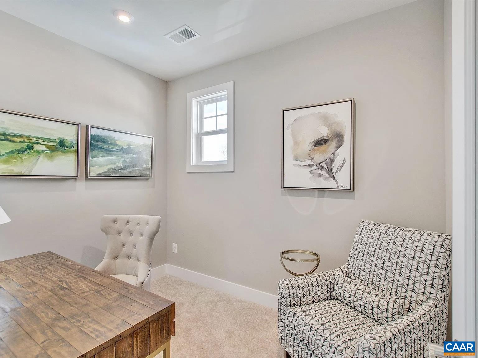 1906 Flora Court Charlottesville, VA 22911 - Photo 14 of 16 a bedroom with a bed and a table in it