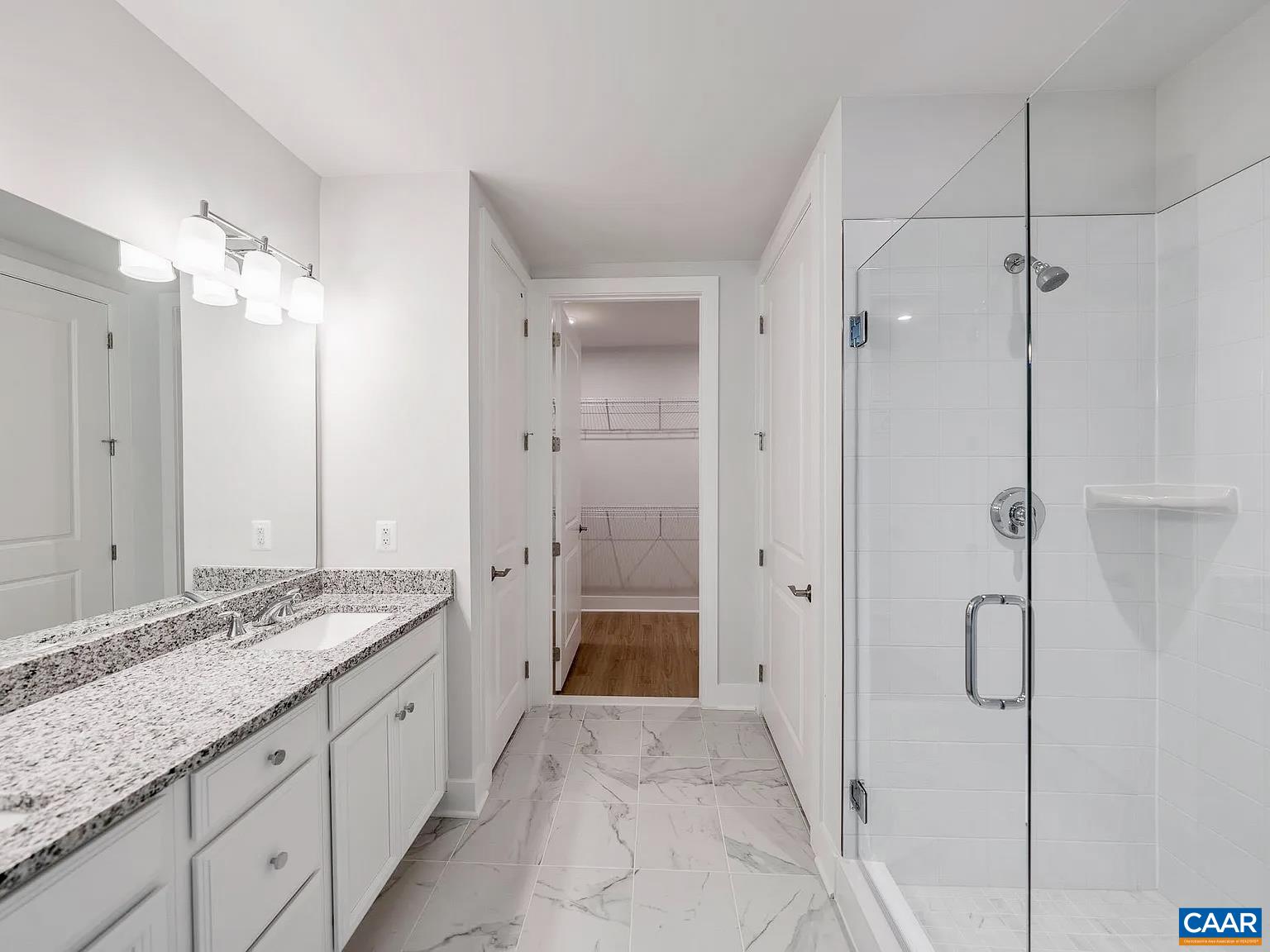 1906 Flora Court Charlottesville, VA 22911 - Photo 8 of 16 a spacious bathroom with a granite countertop sink mirror and shower