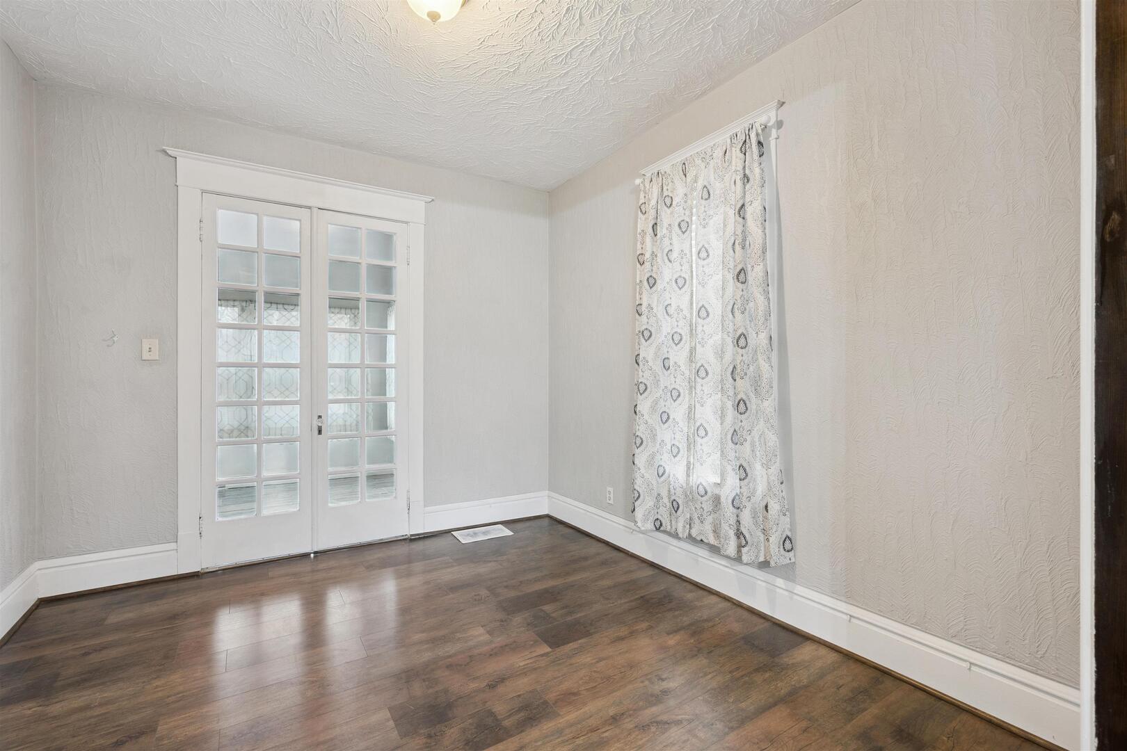 2828 16th Street Moline, IL 61265 - Photo 13 of 39 an empty room with wooden floor and windows